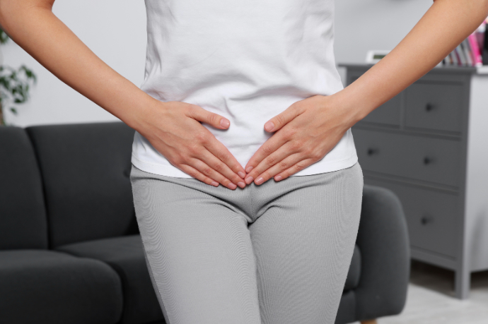 Woman's torso, arms and hands, illustrating a need for diagnosis of common vaginal infections. 